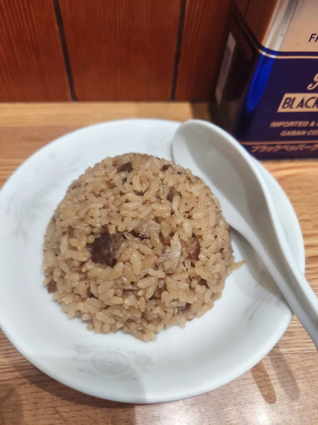 白い小鉢に盛られたミニチャーシュー炊き込みごはん。刻んだチャーシューが混ぜ込まれ、れんげが添えられている
